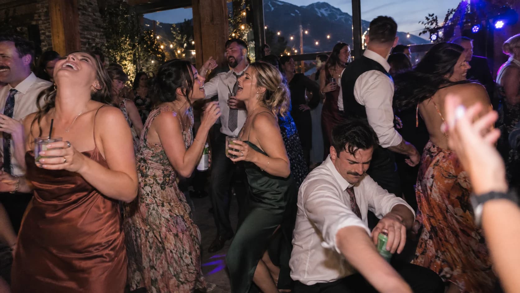 Wedding crowd and dance floor under event lighting